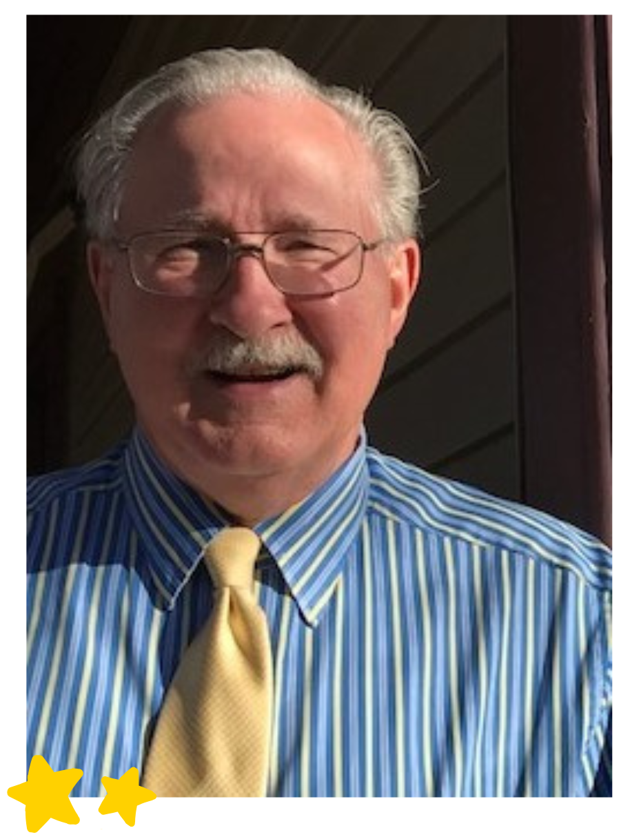 A headshot of Ken Sanders with glasses, and a mustache, smiling and wearing a blue and yellow striped shirt with a yellow tie. Two small yellow stars are in the bottom left corner.