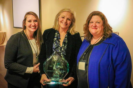 Dr. Kathryn Wells stands with Jade Woodard, Executive Director of Illuminate (left) and Kendra Dunn, Director, Division of Community and Family Support, Colorado Department of Early Childhood, Colorado Child Abuse Prevention Trust Fund (left) after receiving the 2022 Ray E. Helfer, MD, Award