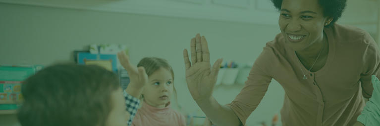 educator giving a high five to a young child